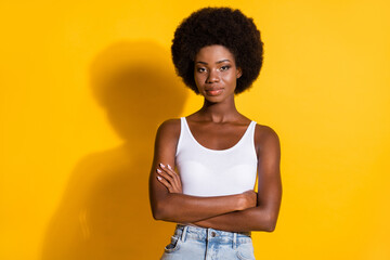 Photo of cool lady folded arms look camera self-assured look camera wear white tank top isolated...