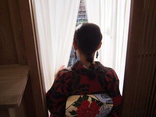 The back of a woman wearing a kimono leaving a ryotei (Japanese-style restaurant), Kyoto, Japan