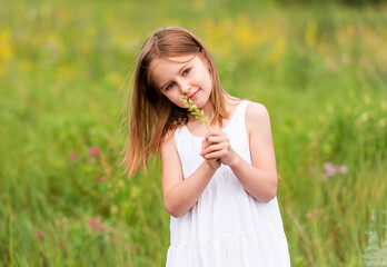 Cute little girl holding wildflower bouquet