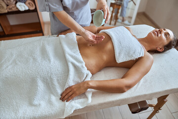 Young atractive female in massage salon is having beauty and healthcare procedures