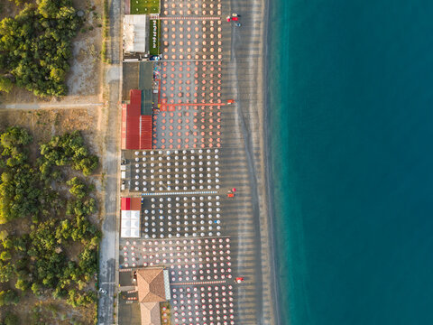 Aerial view of the seashore with parasols and sunbeds in Scalea, Calabria, Italy.
