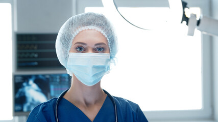 Fototapeta na wymiar Professional medical doctor working in emergency medicine. Portrait of the nurse in protective mask.