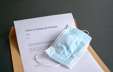 Eviction notice with face mask on top of envelope