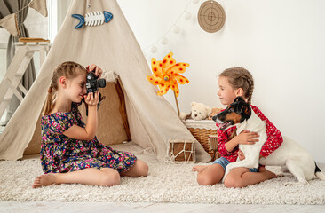 Little girl taking pictures of friend