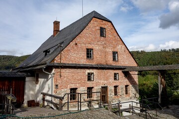 Fototapeta na wymiar The ancient building of Wesselsky water mill built from red bricks in 16th century