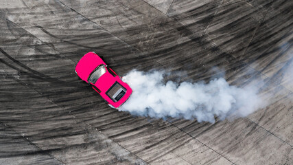 Aerial top view professional driver drifting car on asphalt road track with white smoke, Automobile...