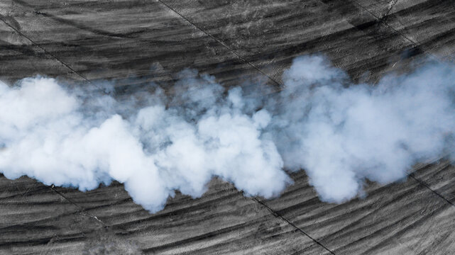 Black Tire Marks And White Smoke On Asphalt Race Track, Road Dust Cloud From Driving Car, Combustion Fumes Of Car Exhaust Pipe, The Engine Is Not Working Properly.