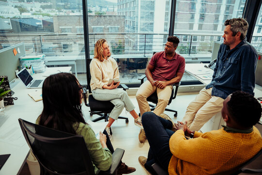 Diverse team of entrepreneurs discussing ideas for new project for new company, preparing for conference meeting