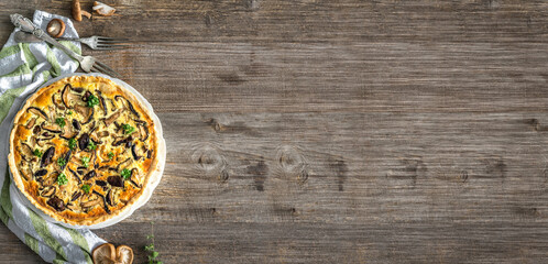 Obraz na płótnie Canvas Homemade pie with mushrooms on a wooden table