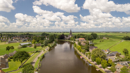 Obraz premium River and village Nieuwekerk aan de Amstel in the Netherlands