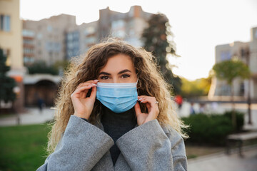 Woman wearing protective mask against coronavirus. Coronavirus COVID-19 pandemic and healthcare concept. Coronavirus precautions