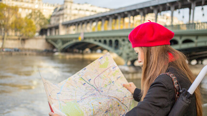  Young stylish woman in red beret and autumn clothing in Paris