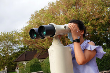 Fototapeta na wymiar person looking through binoculars
