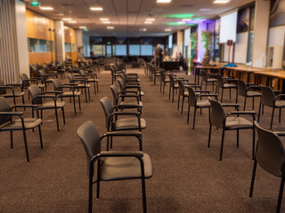 Fototapeta na wymiar Distance between chairs because of corona virus in meeting room lecture hall