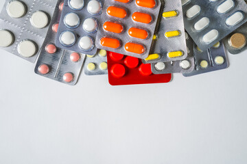 different pills on white background