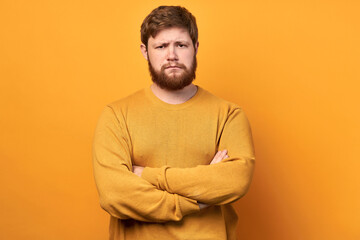 solution. a young cute man gets rid of the problem alone. Confident man with a beard. isolated yellow background