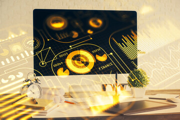 Computer on desktop in office with technology theme hologram. Double exposure. Tech concept.