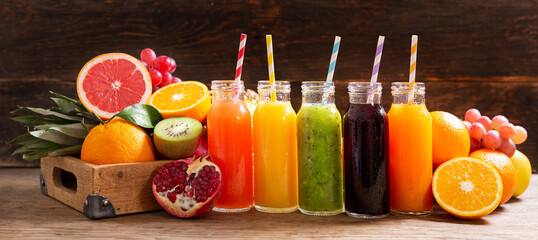 bottles of fruit juice with fresh fruits