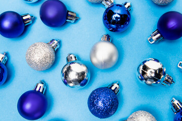 top view of shiny Christmas baubles on blue  background