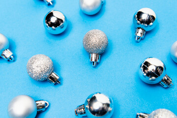 top view of  silver baubles on blue background