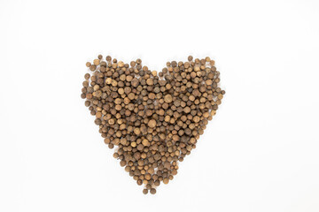 Black peppercorns on white table, flat lay