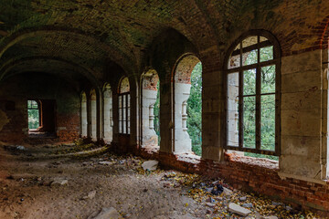 Fototapeta na wymiar Dark corridor of old ancient abandoned red brick ruined historical building