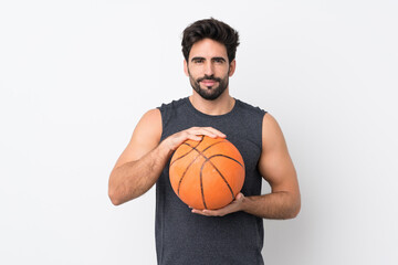 Young handsome man with beard over isolated white background playing basketball