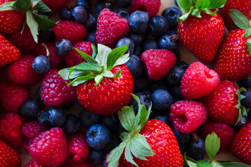 Fresh Strawberry, blueberry and raspberry.Colorful fresh forest fruits background.Healthy food concept.
