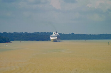 Modern Princess cruiseship or cruise ship liner sails Chagres River during transit of Panama Canal