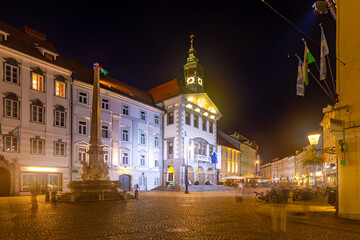 View of illuminated Town Square, major square in Ljubljana with Baroque building of Town Hall at night, Slovenia