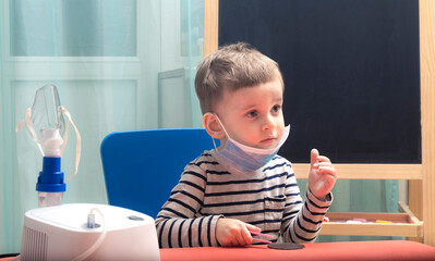 Сhild with protection mask.Young boy with sore eyes in a medical mask. Medical protection against airborne diseases, coronavirus. Сhild is afraid of getting the flu.