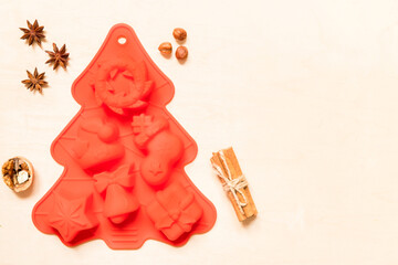 Silicone mold and spices for cooking christmas cookies on wooden background with copy space