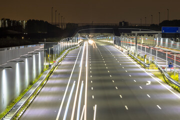 Motorway with entrance of tunnel at night