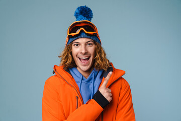 Caucasian excited sportsman pointing finger upward and smiling