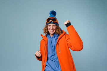 Handsome excited sportsman making winner gesture on camera