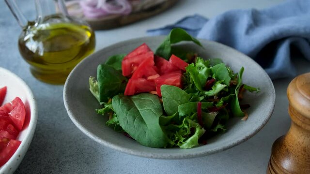 Green salad with tomatoes in a bowl. Vegetarian vegan salad