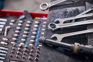 Auto repair kit and wrenches at car service station