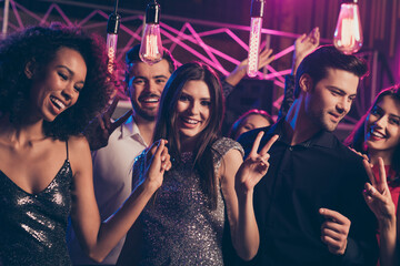 Photo portrait of excited people together showing v-signs dancing at nightclub wearing formal...