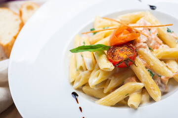 Traditional Italian pasta penne with salmon and creamy sauce.