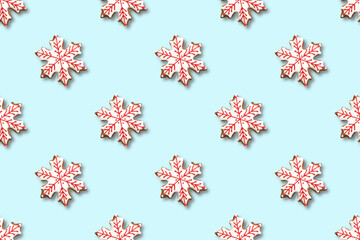 Seamless pattern of Christmas gingerbread in shape snowflake on blue. Xmas abstract background.
