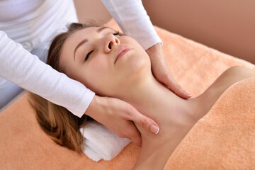 Fototapeta na wymiar Beautiful woman receiving massage from female therapist in spa. Beauty wellness concept