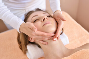 Obraz na płótnie Canvas Beautiful woman receiving massage from female therapist in spa. Beauty wellness concept