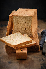 Toast bread with bran on a wooden background. Healthy food.