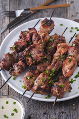 Food photo. Turkey skewers on caps in white plate.