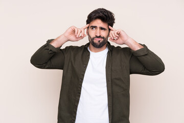 Young handsome man with beard over isolated background having doubts and thinking