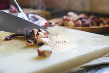 Cutting octopus on kitchen board. © castellanos80