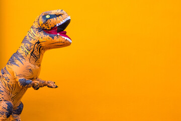 Naklejka premium one big and tall dinosaur enjoying and having fun with orange background - copy and blank space to write your text here
