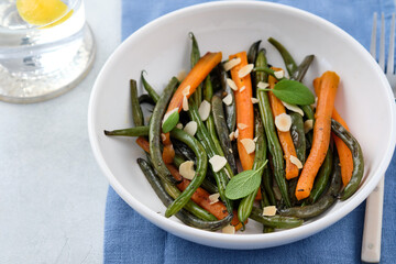 Green beans with carrots cooked with olive oil and sage. Healthy food.