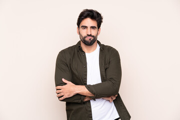 Fototapeta premium Young handsome man with beard over isolated background feeling upset