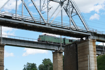 locomotive of the train goes over the bridge over the bridge.